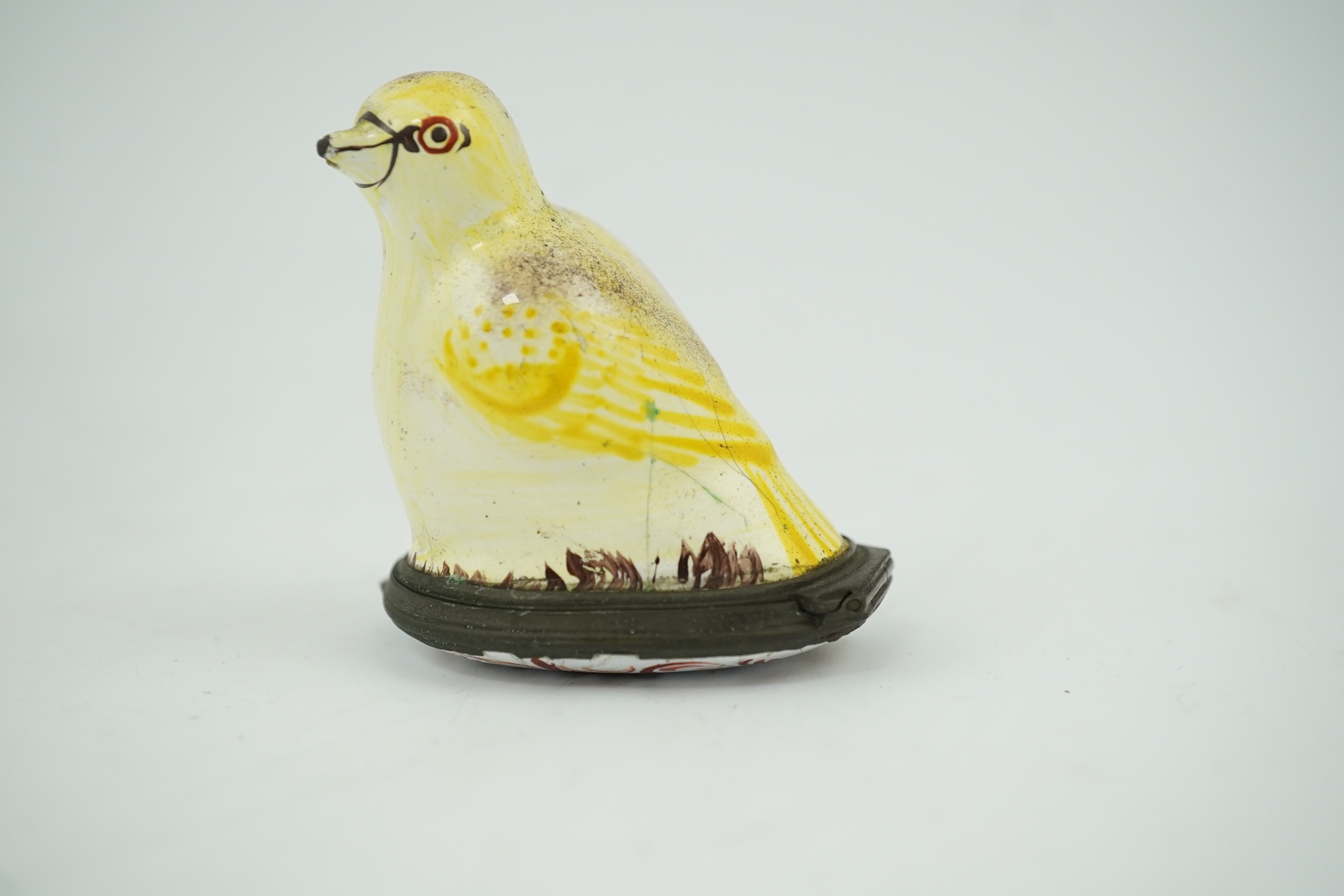 An 18th century South Staffordshire (Bilston) enamel box modelled as a canary with floral decorated lid, 4.5cm high. Condition - fair/poor